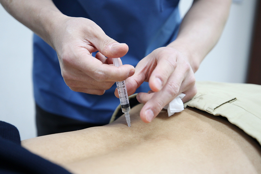 자생한방병원 의료진이 허리 통증을 호소하는 환자에게 약침 치료를 실시하고 있다 (출처 : 자생한방병원) | 자생한방병원・자생의료재단